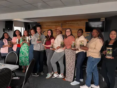 Women of the church holding gifts at a ministry event