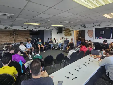 Young people sitting in a circle at a youth gathering